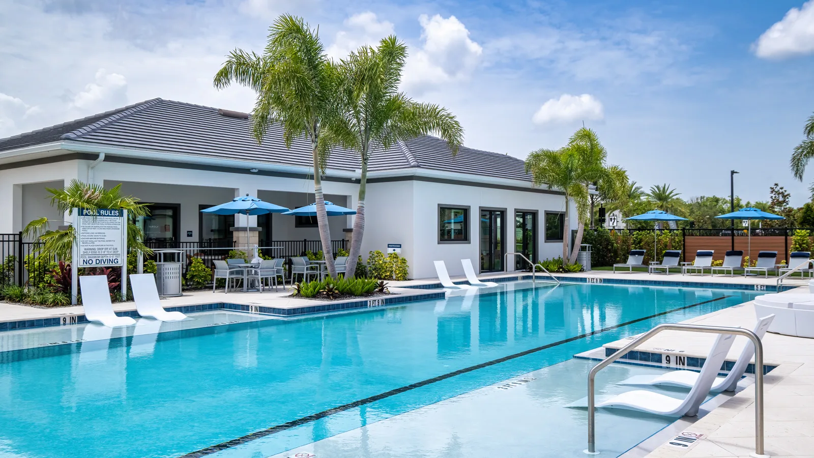 Beautiful photo of the brand-new amenity center and sparkling resort style pool at Yardly Artisan Lakes in Palmetto, FL. This beautiful new home rental community also features a pickleball court, dog park and onsite gym.