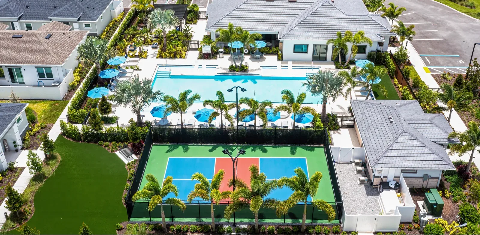 Beautiful photo of the brand-new amenity center and sparkling resort style pool at Yardly Artisan Lakes in Palmetto, FL. This beautiful new home rental community also features a pickleball court, dog park and onsite gym.