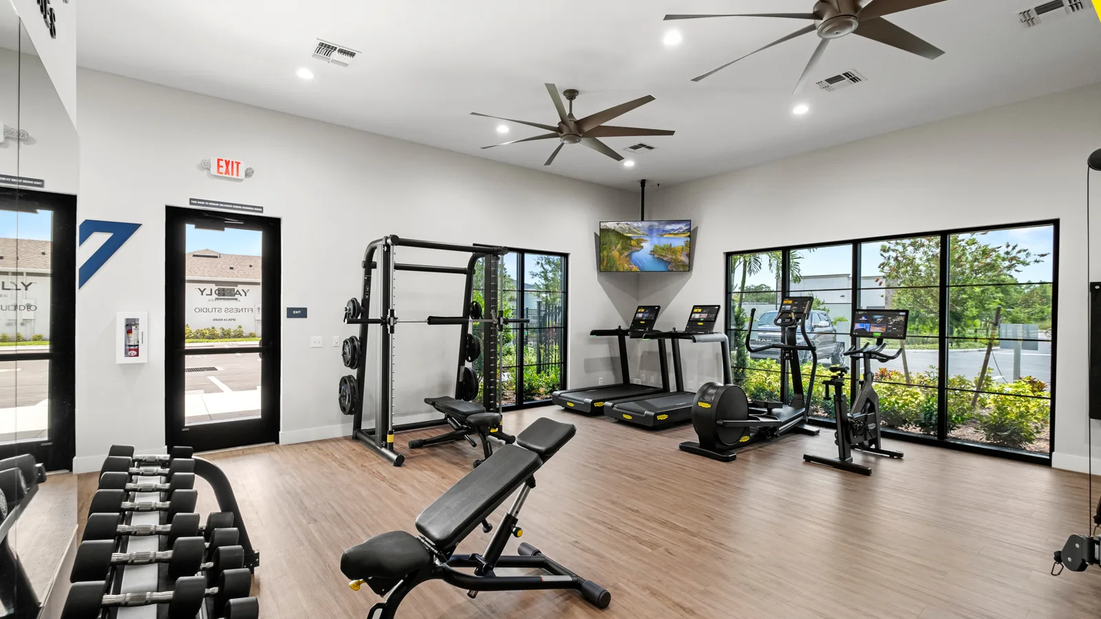 The brand-new onsite fitness center featuring Technogym equipment at Yardly Artisan Lakes in Palmetto, FL. This beautiful community, that boasts 1& 2 bedroom homes with backyards, also features a pool, clubhouse, dog park and pickle ball court.