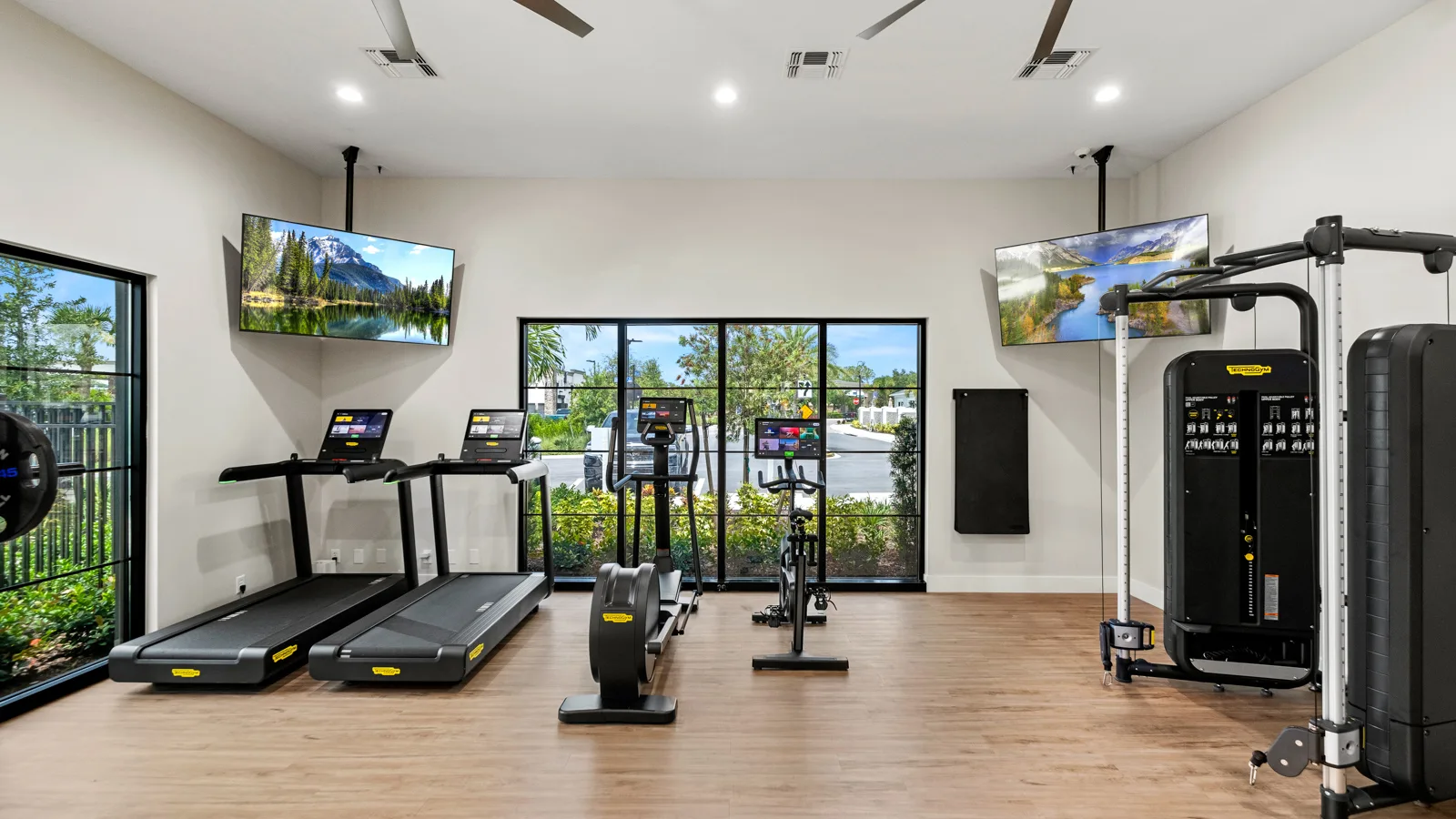 The brand-new onsite fitness center featuring Technogym equipment at Yardly Artisan Lakes in Palmetto, FL. This beautiful community, that boasts 1& 2 bedroom homes with backyards, also features a pool, clubhouse, dog park and pickle ball court.