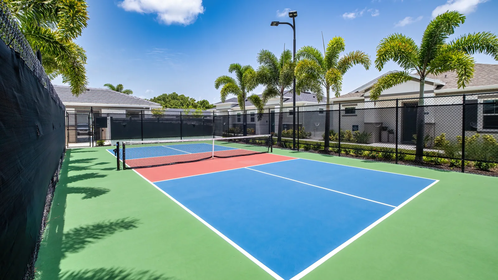 The beautiful brand-new pickle ball court at Yardly Artisan Lakes in Palmetto, FL. This beautiful community also features a pool, clubhouse, dog park and onsite gym.