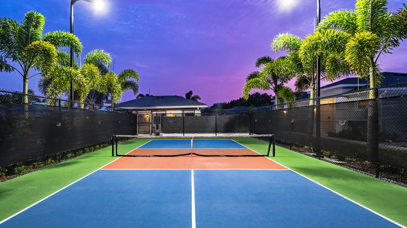 Beautiful twilight photo of the brand-new pickle ball court at Yardly Artisan Lakes in Palmetto, FL. This beautiful community also features a pool, clubhouse, dog park and onsite gym.